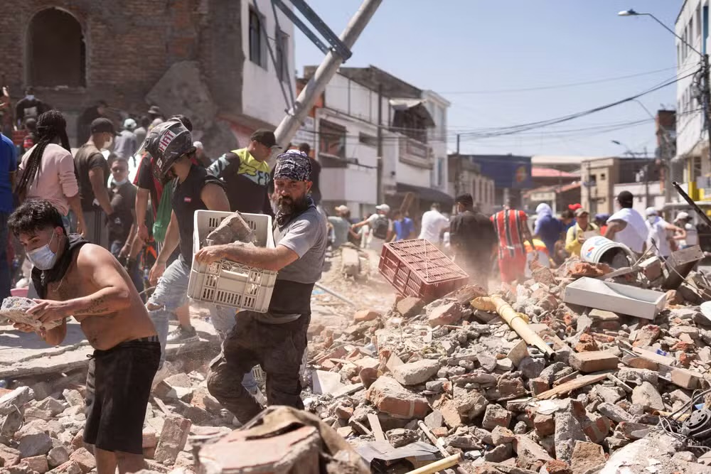 Moradores vasculham escombros de pr&eacute;dio que desabou em terremoto de magnitude de 7,4 em C&aacute;li, na Col&ocirc;mbia, em 10 de agosto de 2026. &mdash; Foto: REUTERS/Camilo Rodriguez
